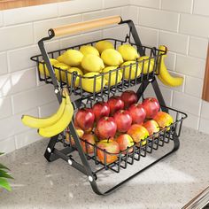 three tiered fruit basket with apples, bananas and lemons