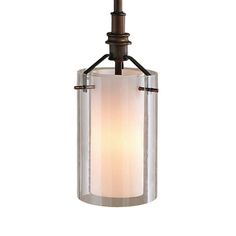 a light hanging from the ceiling with a glass cylinder on it's end and an iron rod at the bottom