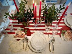 the table is set with candles and place settings