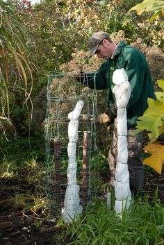 a man is working in the garden with some plants