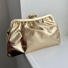 - Vintage Gold Lamé Clutch - Gorgeous metallic gold color - Envelope Clutch with gold hardware (bow) - Measures: 8.5" x 5.5" - Ships free, with tracking, within the United States >> International buyers: Please contact us for a shipping quote before purchase! We do offer international shipping, but don't want to over/undercharge our buyers. Any international purchase with free shipping attached with be automatically cancelled and refunded. Thank you! - Love it and want to buy later? Click on the Clutch Prom, Prom Purse, Metallic Gold Color, Gold Clutch, Gold Lame, Bridal Clutch, Vintage Clutch, Purse Vintage, Envelope Clutch