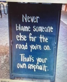 a sign that says never flame someone else for the road you're on that's your own asphalt