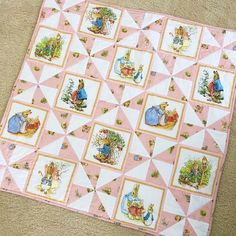 there is a pink and white quilt on the floor with pictures of alice in it