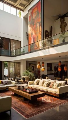 a living room filled with lots of furniture and large painting on the wall above it