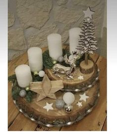 a wooden tray topped with candles and ornaments