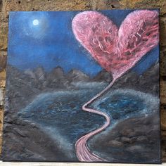 a painting on the side of a building with a heart shaped balloon flying over it