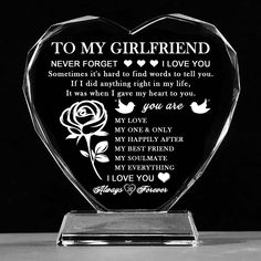 a glass heart shaped award with the words to my girlfriend on it and a rose