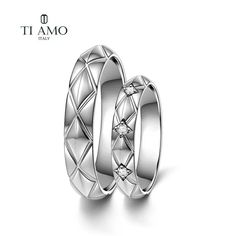 two white gold wedding rings with diamonds on each side and the words ti amo written in