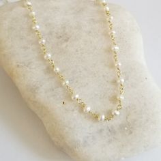 Dainty and oh so pretty, this Freshwater Pearl necklace makes a great everyday boho choker and is ideal for layering with other necklaces in your collection. Available in standard choker length which is 14 inches and sits up high at the neck or your choice of other longer lengths as well.Crafted in natural Pearls. Solid lobster clasp. Pearls are about 3 to 4 mm in size.Details:* Tiny Natural Pearls Rosary Chain* Wire is Sterling Silver with a Rhodium Plating or Gold Version is Sterling Silver wi