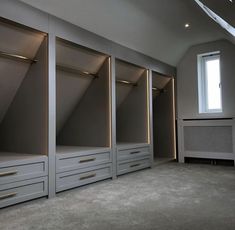 an empty room with some drawers and lights