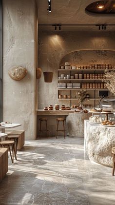 the inside of a restaurant with tables and stools