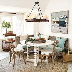 a dining room table with four chairs around it and a rug on the floor next to it