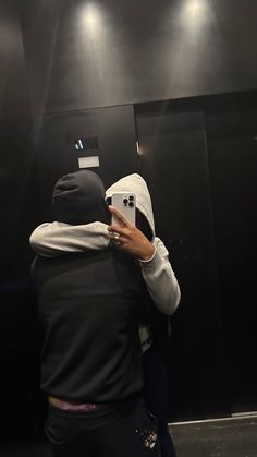 a person taking a selfie in front of a mirror with his cell phone up to his ear