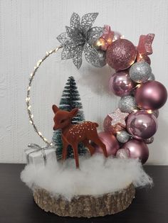 a christmas decoration with ornaments and a deer