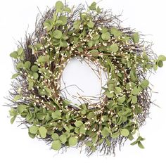 a wreath with green leaves and white berries on it's side, against a white background