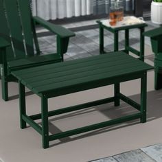 two green chairs and a coffee table in a room with tile flooring on the ground