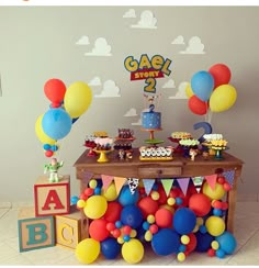 a birthday party with balloons and cake