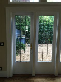 two double doors with sidelights open in front of a home's patio area