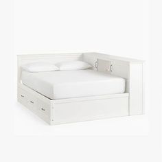 a white bed with two drawers underneath it