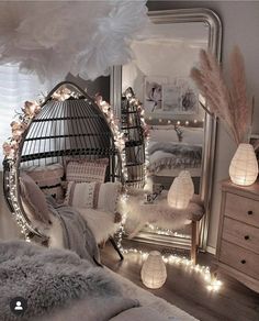 a bedroom decorated with lights and feathers