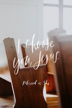 a wooden chair sitting on top of a hard wood floor next to a window with the words i choose you jesus