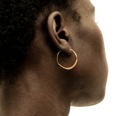 The Amali Threader Hoop Earrings have the same soft, curved quill silhouette as the rest of the Amali styles, with an open-ended hoop that threads through your earlobe. The perfect balance of structure and softness. Handcrafted by artisans in Kenya with 24k gold plated brass using traditional techniques. Maximum thickness: 0.9in (2.5mm)Minimum thickness; 0.05in (1.5mm)Internal Diameter; 0.98in (25mm) Stackable Necklaces, Stacked Earrings, Stackable Bracelets, Open Ended, Wood Jewellery, Chain Choker, Selling Jewelry, Gold Plated Silver, Pop Up Shop