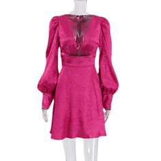 a mannequin wearing a pink dress with long sleeves