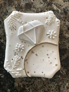 a white plate topped with an ornament on top of a counter