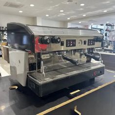 an espresso machine sitting on top of a counter in a store or restaurant