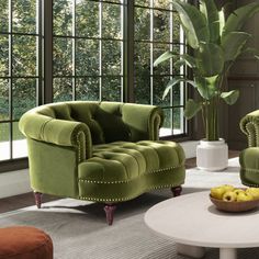 a living room with two green chairs and a coffee table