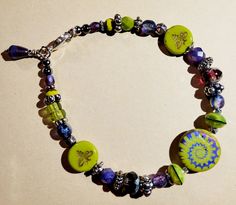 Great combination of chartreuse green and lustrous purple glass beads with silver finish findings. Green Nickel Free Bracelets With Round Beads, Adjustable Green Beads With Silver Accents, Green Faceted Beads Bracelets Of Czech Glass, Green Bracelets With Colorful Glass Beads, Green Czech Glass Bracelets With Colorful Beads, Formal Lime Green Gemstone Jewelry, Lime Green Gemstone Wedding Jewelry, Purple Czech Glass Bracelets With Colorful Beads, Green Glass Bracelets With Colorful Beads