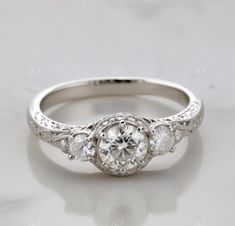 an antique style engagement ring with three stones