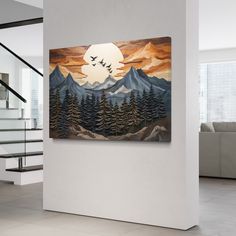 a painting hanging on the wall in a living room with stairs leading up to it