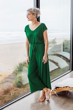 Tired of coordinating tops and bottoms? The Kiova Jumpsuit takes the guesswork out of getting dressed and makes it fun again. The jumpsuit top is a relaxed V-Neck and V-Back with a cap sleeve, connected to a wide leg pant by an elastic waistband with an adjustable drawstring. Did we mention it has pockets? Try one today and let the fun begin. Men's Bedding, Plus Size Western Wear, Tropical Vacations, Wrap Jacket, Eco Friendly Clothing, Let The Fun Begin, Tops And Bottoms, Getting Dressed, Wide Leg Pant