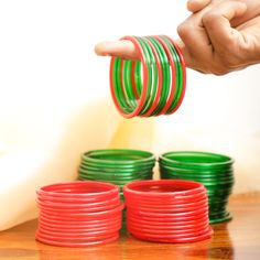 India’s favorite handmade glass bangles are a symbol of an honored wife and mother. In most Hindu families, the maternal family gifts red and green glass bangles to the new bride. The different colors of bangles hold unique meanings. For example, the color red means energy, green is a reminder of the wedding, yellow signifies happiness, and gold symbolizes fortune. Evergreen and always a welcome sight, here is a set of multicolored glass bangles. They make a great accessory for a traditional or Festive Green Bangle As Gift, Festive Green Bangle For Gift, Green Glass Bangles, Red Means, Indian Baby Showers, Traditional Women, Wedding Yellow, Red Meaning, Ladies Bangles