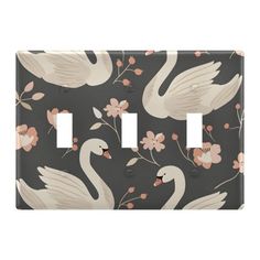 two white swans on a black background with pink flowers and leaves switchplate covers are shown