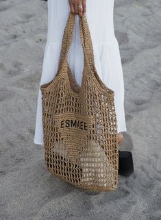 Esmaee tote bag design is made of raffia-effect yarn A light, natural material with a summery mood. Front is embellished at its center with the embroidered lettering logo. Raffia-effect yarn Crochet workmanship Height: 38cm Width: 36cm Length: 3cm Neutral Woven Crochet Bag For Summer, Summer Neutral Woven Crochet Bag, Summer Woven Neutral Crochet Bag, Eco-friendly Neutral Beach Bag For Summer, Summer Neutral Crochet Tote Bag, Beige Straw Bag For Market And Beach Season, Beige Straw Bag For Market In Beach Season, Eco-friendly Crochet Bag For Beach Shopping, Summer Crochet Beach Bag In Neutral Color