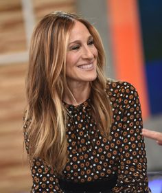 the actress is smiling while sitting down