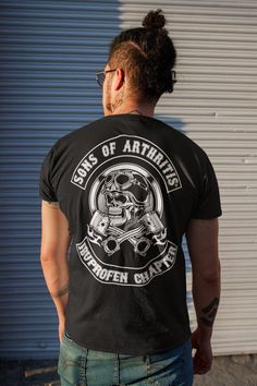 "The one and only Sons of Arthritis® is a registered brand. When you buy from us you know you are getting the authentic shirts that started a revolution in the biker community. Don't trust the copycats out there. There is only one true Sons of Arthritis LLC. www.sonsofarthritis.com When you're a biker at heart despite the fact that every bone in your body hurts due to age. This funny shirt is perfect for you! You can purchase and make it as a gift for Father's Day. ABOUT OUR TEES 👕 Our unisex t Cotton Biker Top For Biker Events, Punk Style Crew Neck T-shirt For Biker Events, Screen Print Tops For Biker Events, Biker Style T-shirt With Front Print For Biker Events, Biker Style Cotton Shirt For Streetwear, Biker Style Cotton T-shirt With Screen Print, Punk Style Short Sleeve T-shirt For Biker Events, Black Biker Style Fan Merchandise Tops, Cotton Biker Shirt For Biker Events