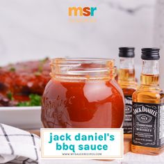 jack daniels bbq sauce in a glass jar next to two bottles of barbecue sauce