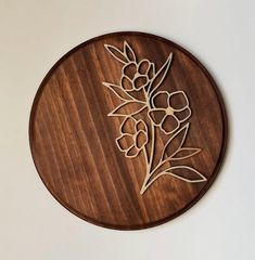 a wooden cutting board with flowers on it