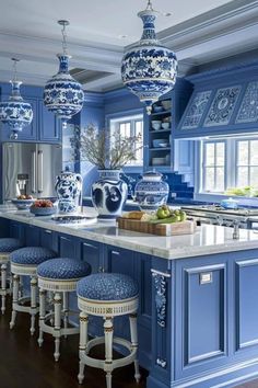 a kitchen with blue and white decor on the walls, counter tops and stools