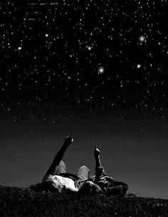 two people laying down under the stars in the night sky with an inspirational quote above them