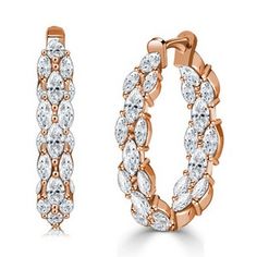 a pair of rose gold hoop earrings with white stones on the inside and outside of them