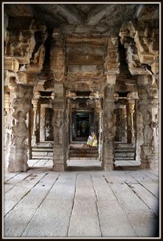 the interior of an ancient temple with carved pillars