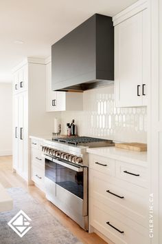 Custom kitchen range hood in a matte black finish. Kitchen Hood Fan, White Wood Kitchen, Black Range Hood, Modern Stoves, White Wood Kitchens, Modern Black Kitchen