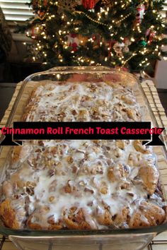 cinnamon roll french toast casserole with white icing in front of a christmas tree