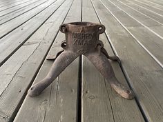 an old metal object sitting on top of a wooden floor