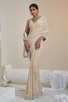 Eggshell pre-draped saree with pearl embroidery details in georgette base. Paired with a padded sleeveless blouse.
Components: 2
Pattern: Embroidered
Type Of Work: Pearl
Neckline: V Neck
Sleeve Type: Sleeveless
Fabric: Georgette, Net
Color: Beige
Other Details: 
Attached lining
Blouse length: 12.5 inches
Occasion: Mehendi and Haldi - Aza Fashions Elegant Georgette Pre-draped Saree With Zari Work, Elegant Fitted Pre-draped Saree With Mirror Work, Elegant Pre-draped Saree With Sheer Dupatta In Georgette, Elegant Pre-draped Georgette Saree With Sheer Dupatta, Elegant Pre-draped Georgette Saree With Zari Work, Elegant Fitted Pre-draped Saree With Pearl Embroidery, Elegant Designer Georgette Pre-draped Saree, Elegant Georgette Pre-draped Saree For Designer Wear, Elegant Georgette Saree For Reception