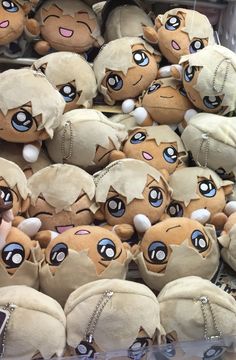 a pile of stuffed animals sitting next to each other on top of a shelf in a store